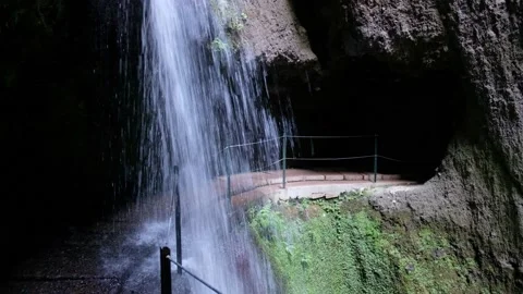 Amazing waterfall deep inside of the mountain. Tunnel, cave passage for hikers. Stock Footage 172187943