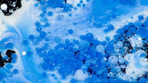 Amazing white and blue bubbles of paint on the oil surface. Paint in oil. Video stock 105186399