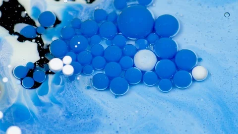 Amazing white and blue bubbles of paint on the oil surface. Paint in oil. Video stock 105187103