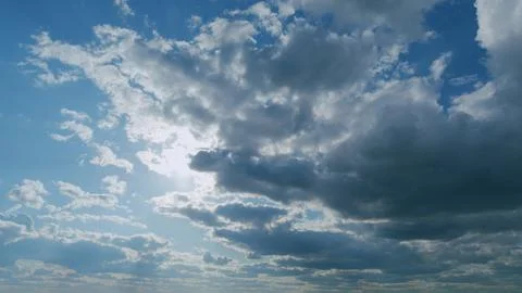 Amazing white fluffy clouds moving softly on bright blue sky. Change of weather Stock Photos