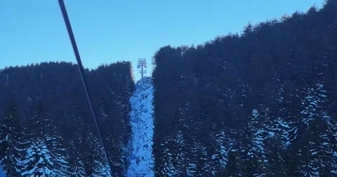 Amazing winter sunset as viewed from a ski lift, featuring a snow-covered for Stock Footage 296358356