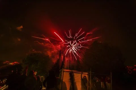Amazinv red firework in the sky over Pamplona city. HAPPY NEW YEAR! Stock Photos