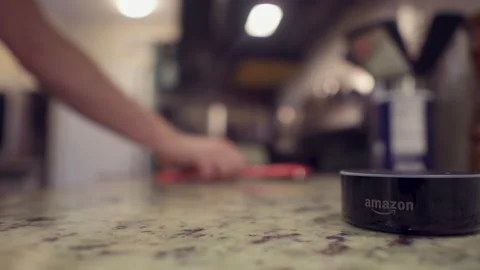 Amazon Alexa Echo Dot helping cook in kitchen Stock Footage 131570944