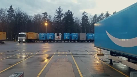 Amazon and DHL delivery trailer trucks at loading docks of warehouse shipping Stock Footage 333488585