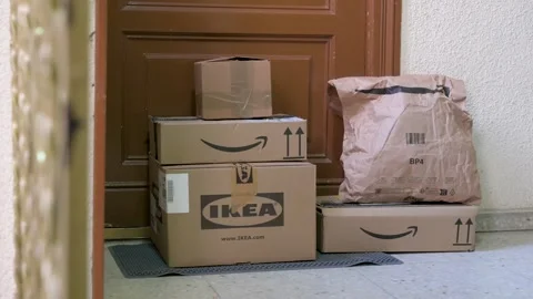 Amazon and Ikea order delivery packages seen in front of a customer door. Vídeos de archivo 249714718
