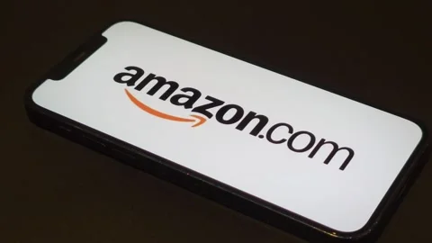Amazon company logo displayed on mobile phone Stock Footage 321143438