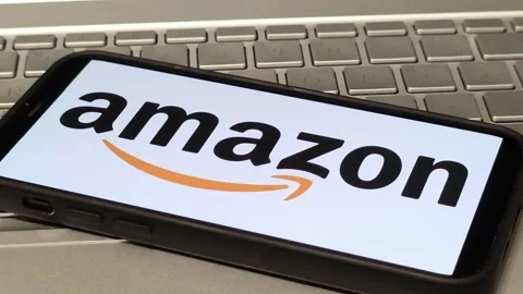 Amazon company logo displayed on mobile phone Stock Footage 324704718