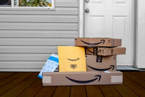 Amazon deliver boxes and envelopes at a home entrance just delivered. Stock Photos