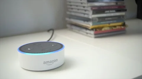 Amazon Dot Activating With A Stack of CDs In The Background Stock Footage 86153438