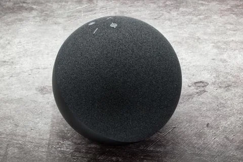 Amazon Echo Dot. Alexa, virtual assistant AI. Grey concrete background Stock Photos