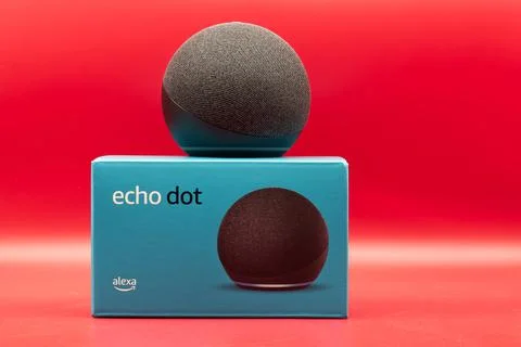 Amazon Echo Dot. Alexa, virtual assistant AI. Red background Stock Photos