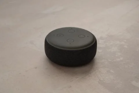 Amazon Echo Dot and Alexa with a concrete stone background. Stock Photos