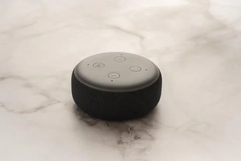 Amazon Echo Dot and Alexa with a light marble background. Stock Photos