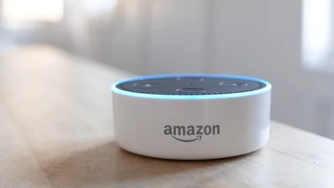 Amazon Echo Dot lights up with a command after it is revealed.  Editorial clip. Stock Footage 103347506