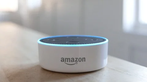 Amazon Echo Dot lights up as it answers a command.    Editorial clip. Video stock 103347488