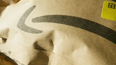 Amazon envelope package close-up visual from back of the arrow to the start Stock Footage 332377125