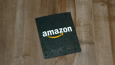 An Amazon gift card pack on wooden background. Stockbeeldmateriaal 331187344