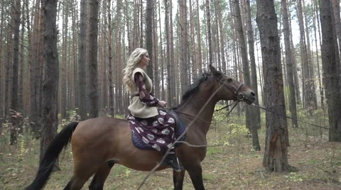 Amazon on horseback in the woods Stock Footage 49022812