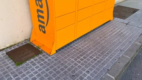 Amazon hub Locker pick up point in Spain, 4K tilting up Video stock 122948298
