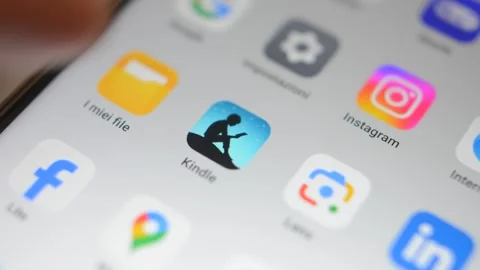 Amazon kindle app on phone display. e-reader e-book kindle book open app. Video stock 299896773