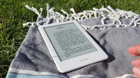 Amazon Kindle e-book reader hand swipe Stock Footage 250453996