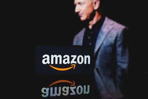 Amazon logo and Jeff Bezos in the background Stock Photos