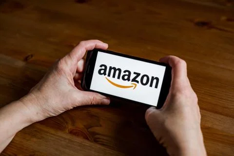 Amazon logo sign application screen on mobile phone online retail service, hands 写真素材