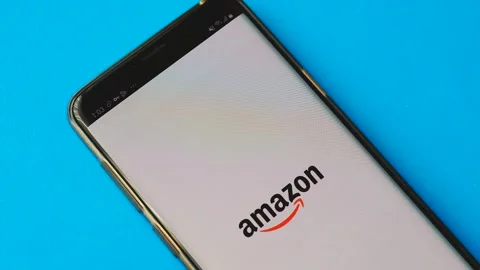 Amazon mobile application is launched on a smartphone, close-up. Amazon online s Stock Footage 208898775