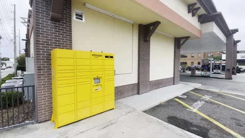 Amazon outdoors locker pick up outside of a 7-11 Stock Footage 256802705