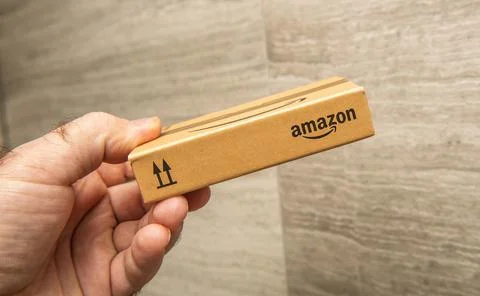 Amazon package held in hand Stock Photos