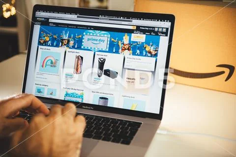 Amazon Prime day man shopping on laptop deals Stock Photos