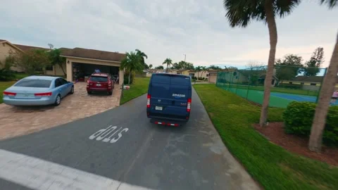 Amazon prime delivery van driving through nice residential Florida Stock Footage 233944750