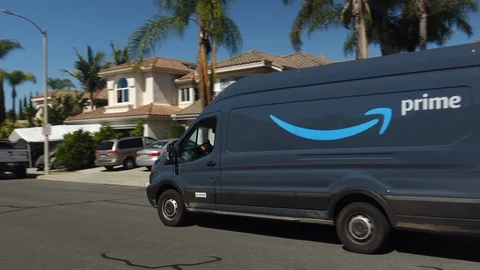 Amazon Prime delivery van out on deliveries in suburban neighborhood. Stock Footage 129185554