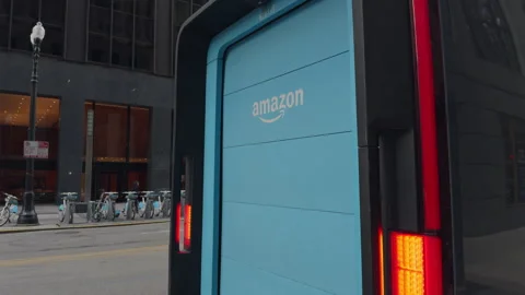 Amazon Prime driver delivers package to local on a new electric van in downtown Video stock 294144877