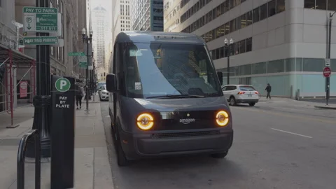 Amazon Prime driver delivers package to local on a new electric van in downtown. Video stock 294145385