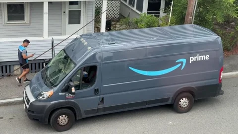 Amazon Prime driver returns to truck after delivering a package Video stock 251498626