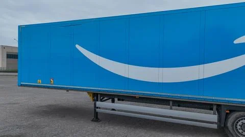 Amazon Prime logistics trailer positioned near a rural industrial area with.. Stock Photos