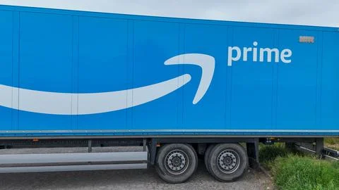 Amazon Prime logistics trailer positioned near a rural industrial area with.. Stock Photos