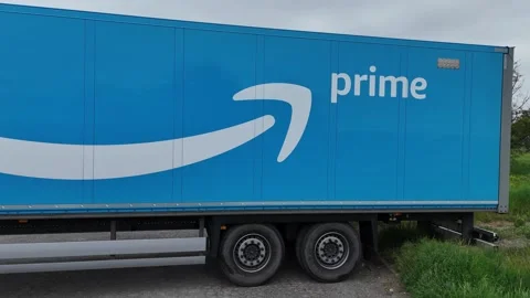 Amazon Prime trailer with blue livery and logo parked roadside logistics Stock Footage 335185988