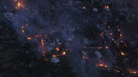 Amazon rainforest fire overhead aerial shot. Drone view glow and flames Stock Footage