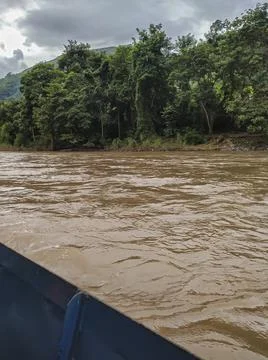 Amazon river with the background full of green mountains and blue sky with cl Stock Photos