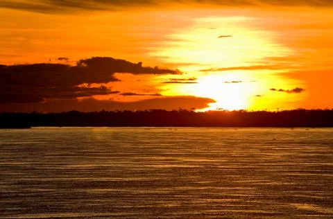Amazon River Sunset with Dramatic Orange Sky and Silhouette Stock Photos