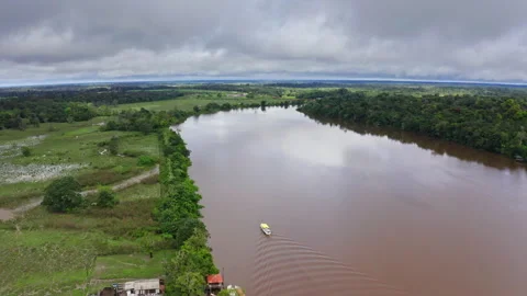 Amazon Seen from Above Tropical Forest and Boat in Murky Water Stock Footage 311411468