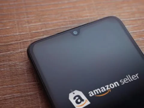 Amazon Seller app launch screen on smartphone on wooden background Stock Photos
