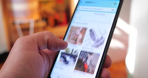 Amazon shopping app browsing online mobile shopping feed Stock Footage 136636225
