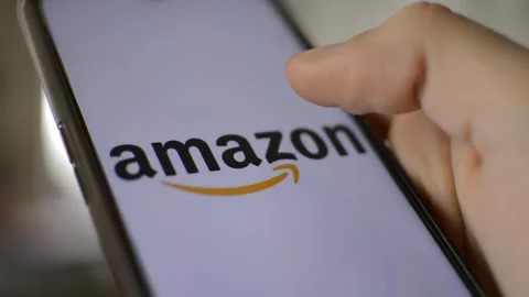 Amazon shopping app logo on the phone display in a blur modern intern. Stock Footage 237429928