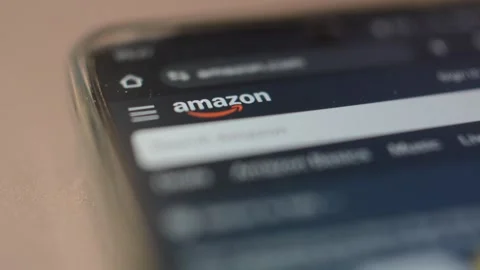 Amazon shopping app on phone device screen. amazon marketplace for commerce. Stock-Footage 302345022