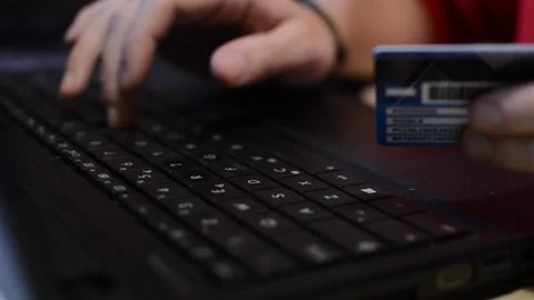 Amazon shopping payment. man's hand with credit card pay on the amazon website. Stock Footage 228911954