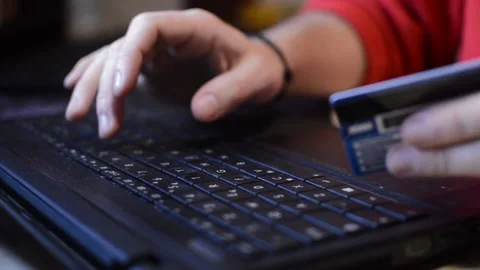 Amazon shopping payment. man's hand with credit card pay on the amazon website. Stock-Footage 228917927