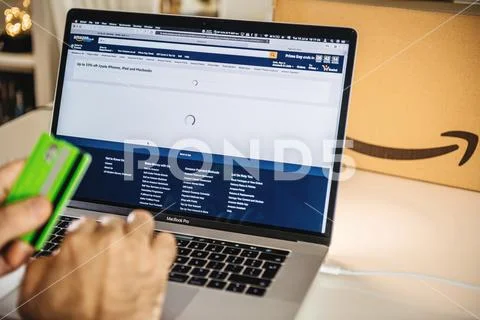 Amazon UK Prime day man shopping on laptop deals credit card Stock Photos